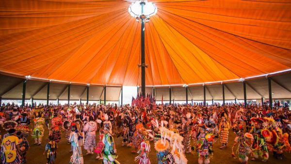 members attending annual Kalispel Pow-Wow in a large tent