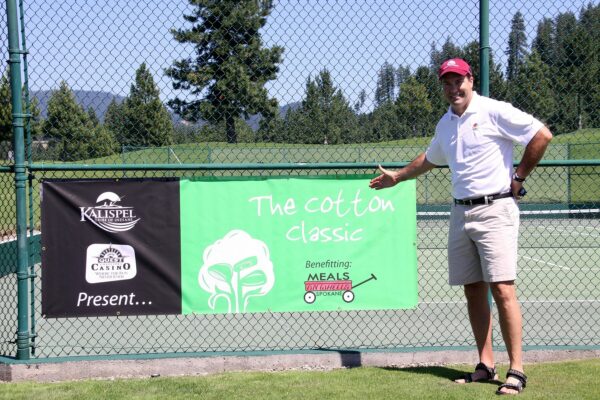 man pointing to Meals on Wheels banner