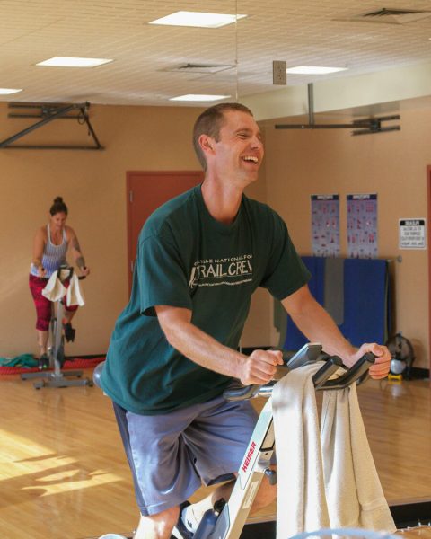 two people using exercise bikes